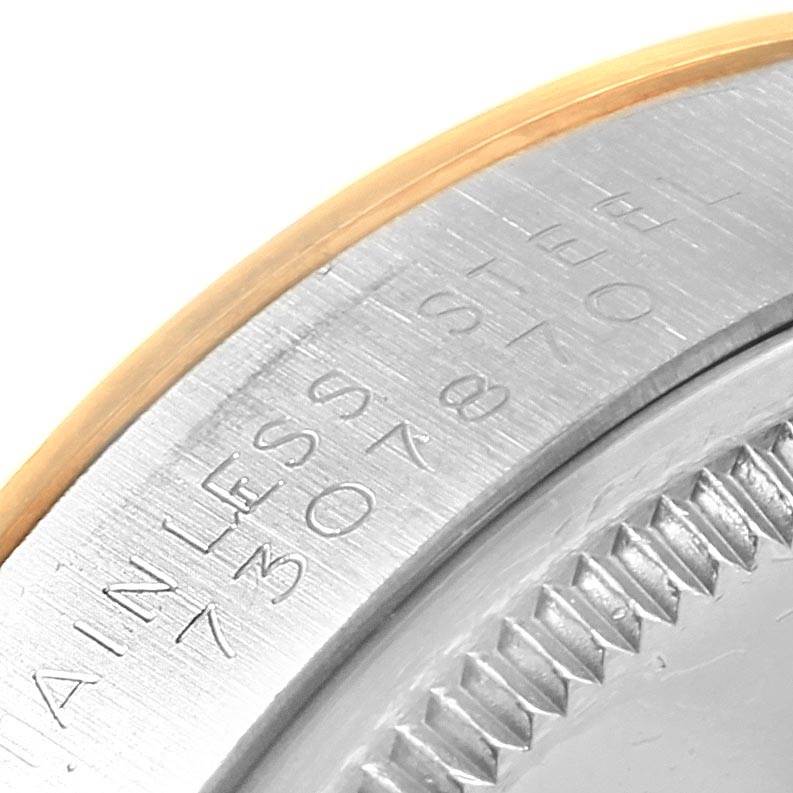 This close-up image shows the engraved outer rim and bezel edge of a Rolex Vintage Collection 5501 Men's Steel and Gold (two tone) Silver Dial 5501 Men's Steel and Gold (two tone) Silver Dial watch.