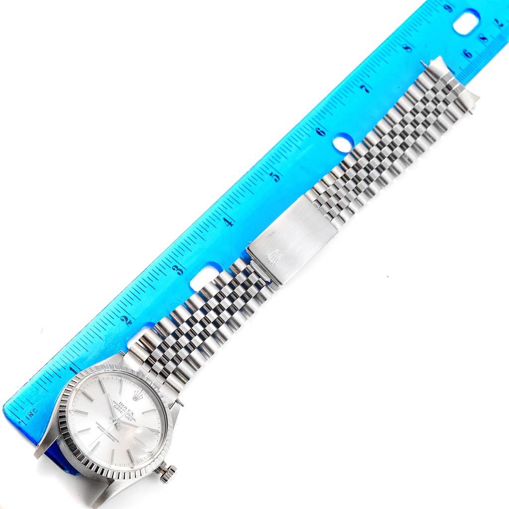 This Rolex Vintage Collection 16030 Men's Stainless Steel Silver Dial 16030 Men's Stainless Steel Silver Dial watch is shown from a top-down angle, displaying the face, bezel, crown, and entire bracelet alongside a ruler for scale.