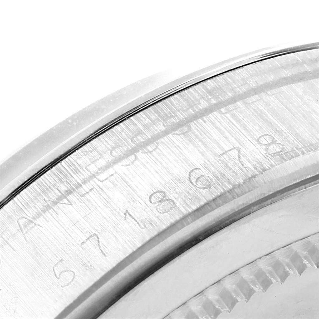 The image shows a macro shot of the side engraving and bezel edge of the Rolex Vintage Collection 6694 Men's Champagne Dial 6694 Men's Champagne Dial watch.