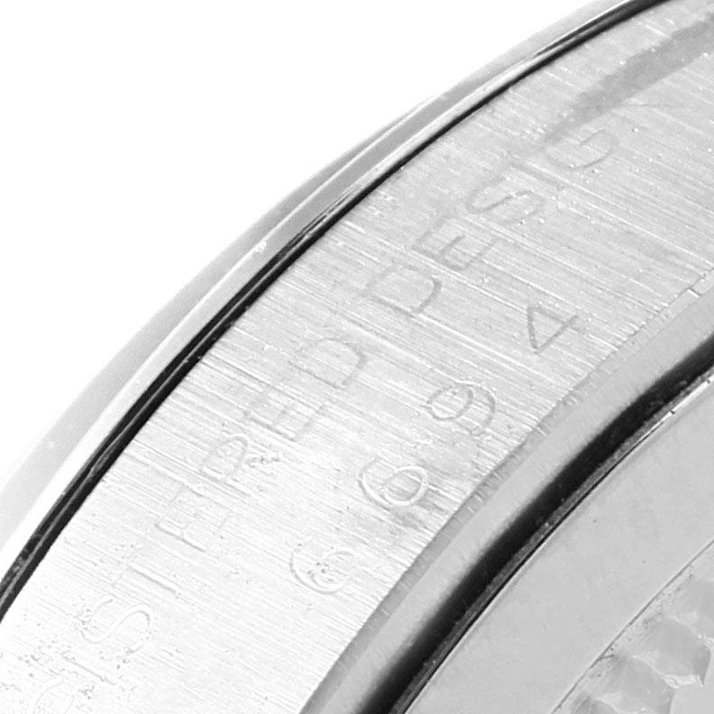 This image shows a close-up of the bezel and part of the case of a Rolex Vintage Collection 6694 Men's Champagne Dial 6694 Men's Champagne Dial watch.