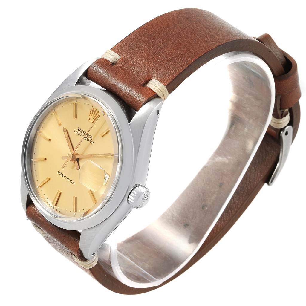 The Rolex Vintage Collection 6694 Men's Champagne Dial 6694 Men's Champagne Dial watch is shown from a three-quarter side angle, displaying its dial, case, crown, and brown leather strap.