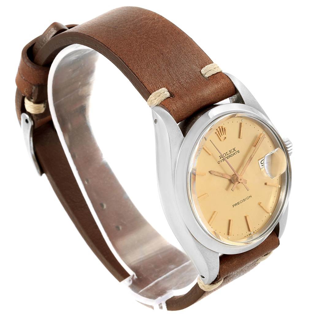 The Rolex Vintage Collection 6694 Men's Champagne Dial 6694 Men's Champagne Dial watch is shown at a side angle, highlighting its beige dial, leather strap, and date display.