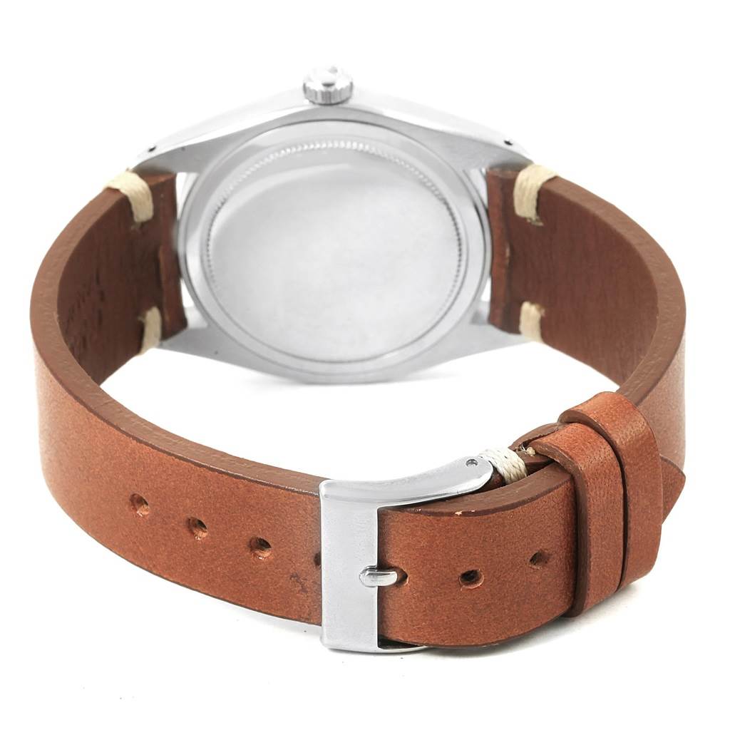 The image shows the back view of a Vintage Collection Rolex watch with a brown leather strap and silver buckle.