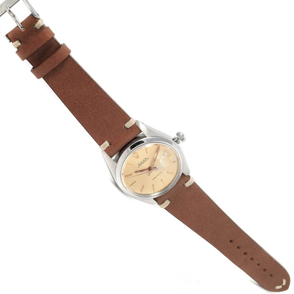 The Rolex Vintage Collection 6694 Men's Champagne Dial 6694 Men's Champagne Dial watch shows a tan dial and brown leather strap from a tilted angle.