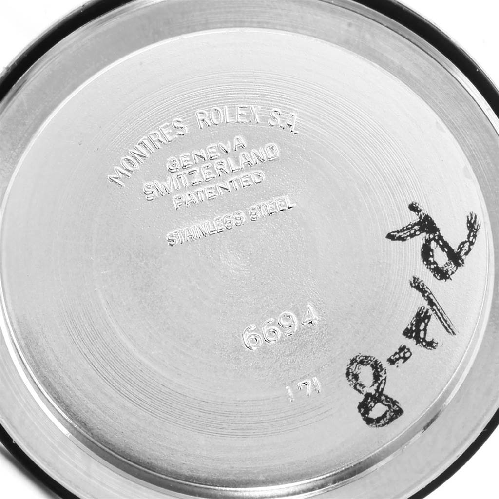 The image shows the inner side of the back case of a Rolex Vintage Collection 6694 Men's Stainless Steel Silver Dial 6694 Men's Stainless Steel Silver Dial watch with detailed engravings.