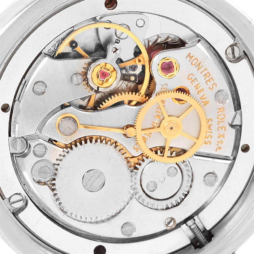 The image shows the intricate inner mechanical movement of a Vintage Collection model by Rolex.