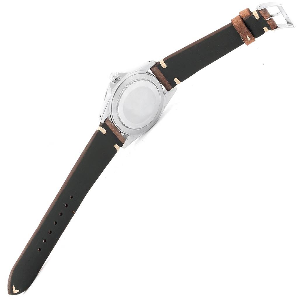 The image shows the back case and leather strap of a Rolex Vintage Collection 1675 Men's Stainless Steel Black Dial 1675 Men's Stainless Steel Black Dial watch.