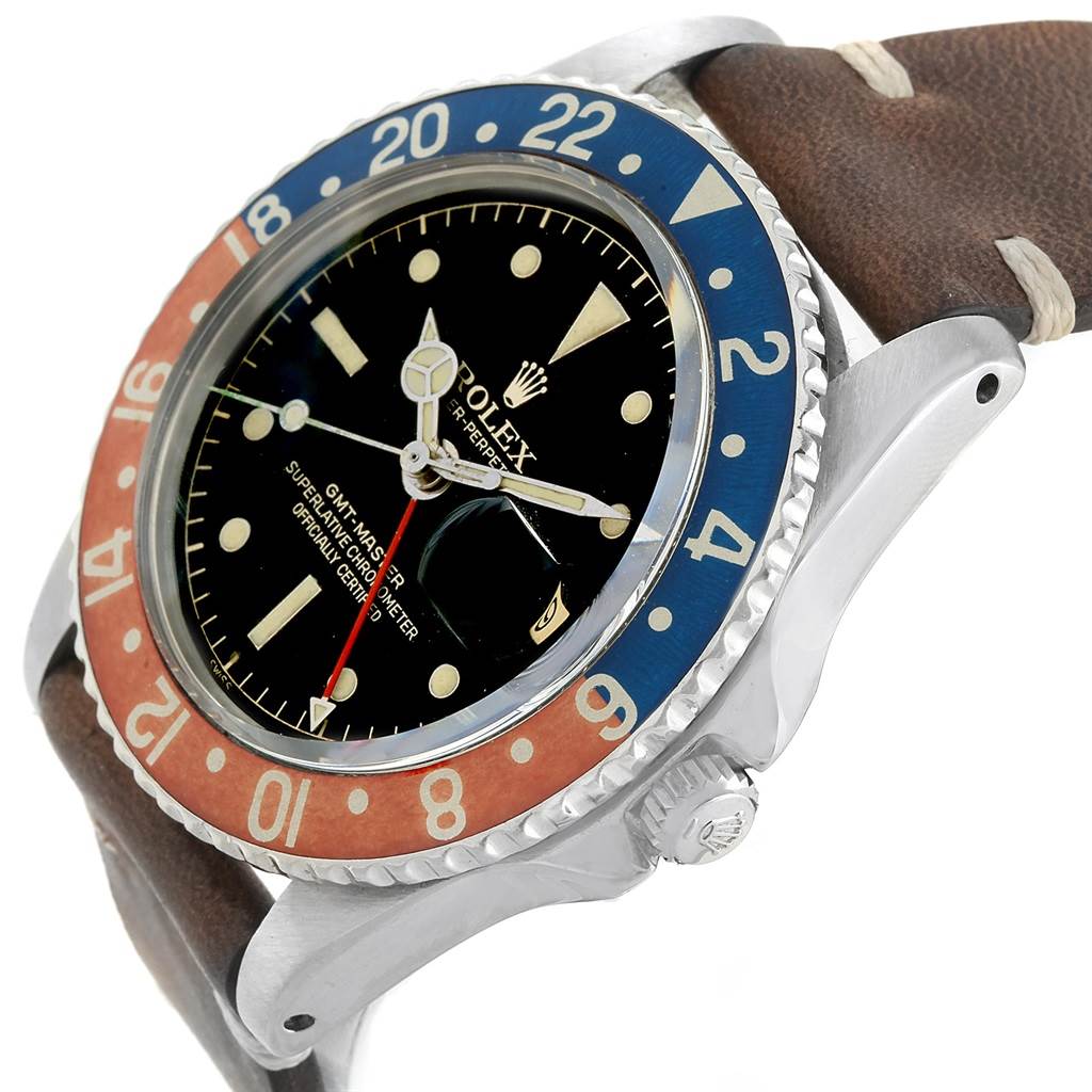 The Vintage Collection Rolex watch is shown at an angle highlighting the face, bezel, crown, and part of the leather strap.