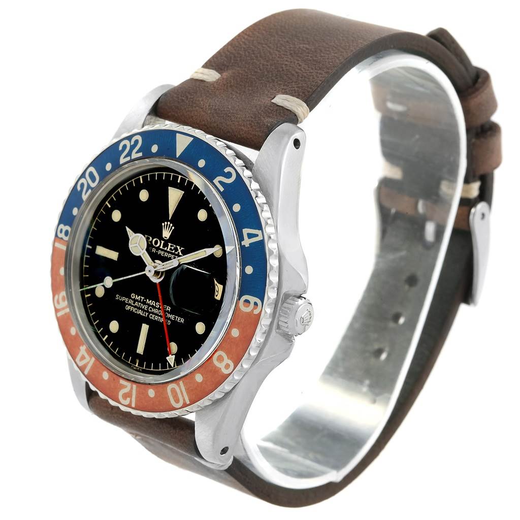 This image shows a three-quarter view of a Rolex Vintage Collection 1675 Men's Stainless Steel Black Dial 1675 Men's Stainless Steel Black Dial watch, highlighting its bezel, face, and leather strap.