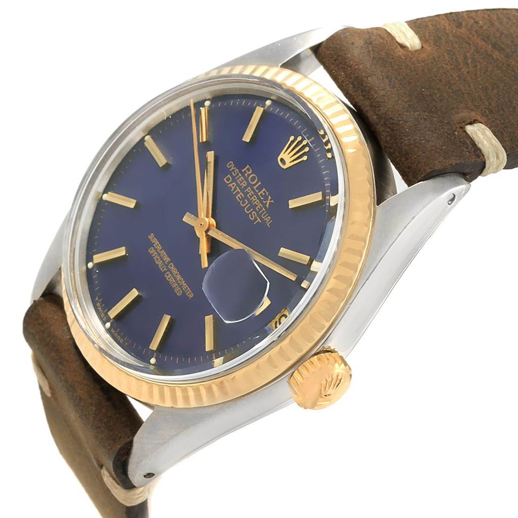 The picture shows a Rolex Vintage Collection 1601 Men's Steel and Gold (two tone) Blue Dial 1601 Men's Steel and Gold (two tone) Blue Dial watch at an angle highlighting the dial, bezel, crown, and leather strap.