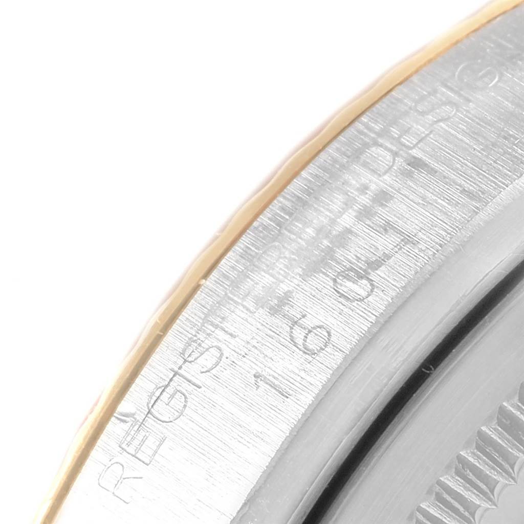 This is a close-up of the side edge of a Rolex Vintage Collection 1601 Men's Steel and Gold (two tone) Blue Dial 1601 Men's Steel and Gold (two tone) Blue Dial model, showing engraved text and part of the bezel.