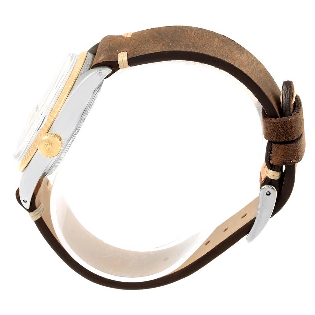 The image shows a side view of the Rolex Vintage Collection 1601 Men's Steel and Gold (two tone) Blue Dial 1601 Men's Steel and Gold (two tone) Blue Dial watch, highlighting the case, crown, and the leather strap.