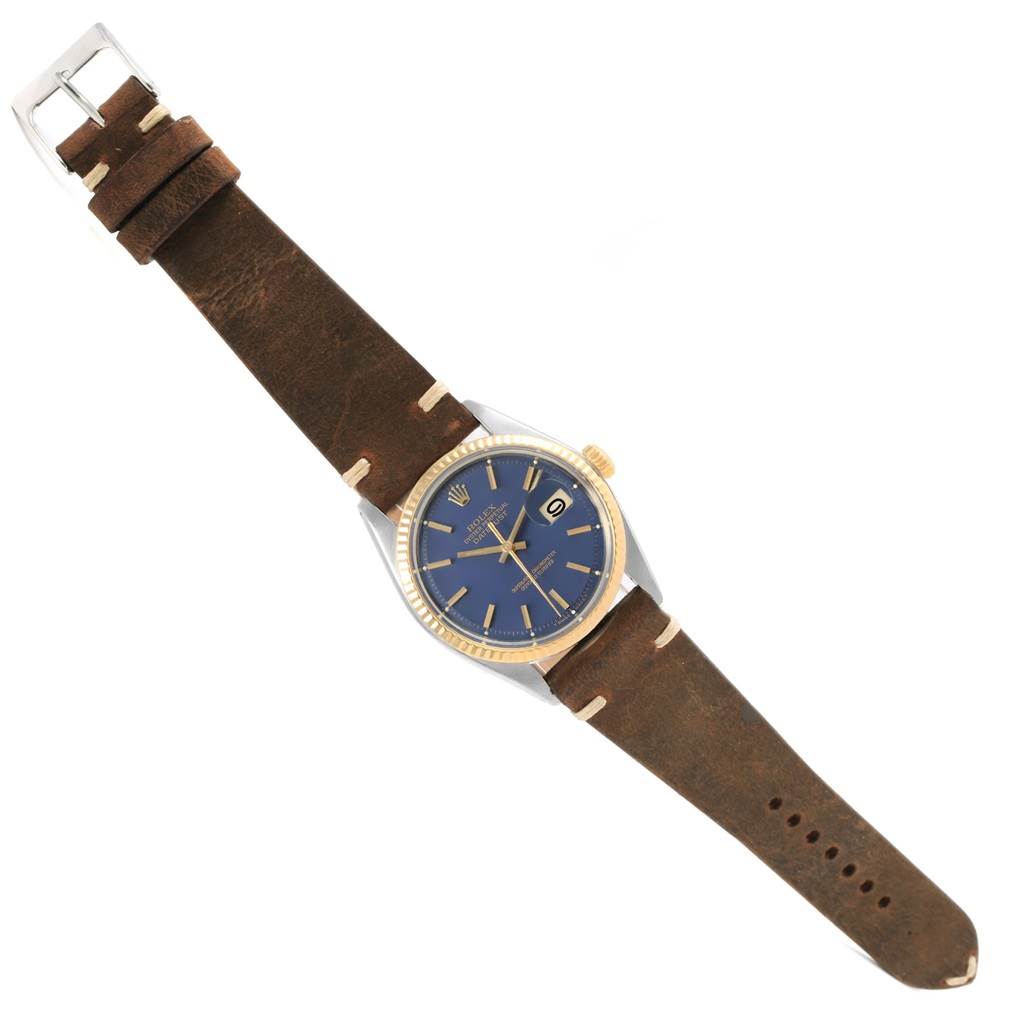 The Rolex Vintage Collection 1601 Men's Steel and Gold (two tone) Blue Dial 1601 Men's Steel and Gold (two tone) Blue Dial watch is shown from a top-down angle, highlighting the face, bezel, crown, and leather strap.