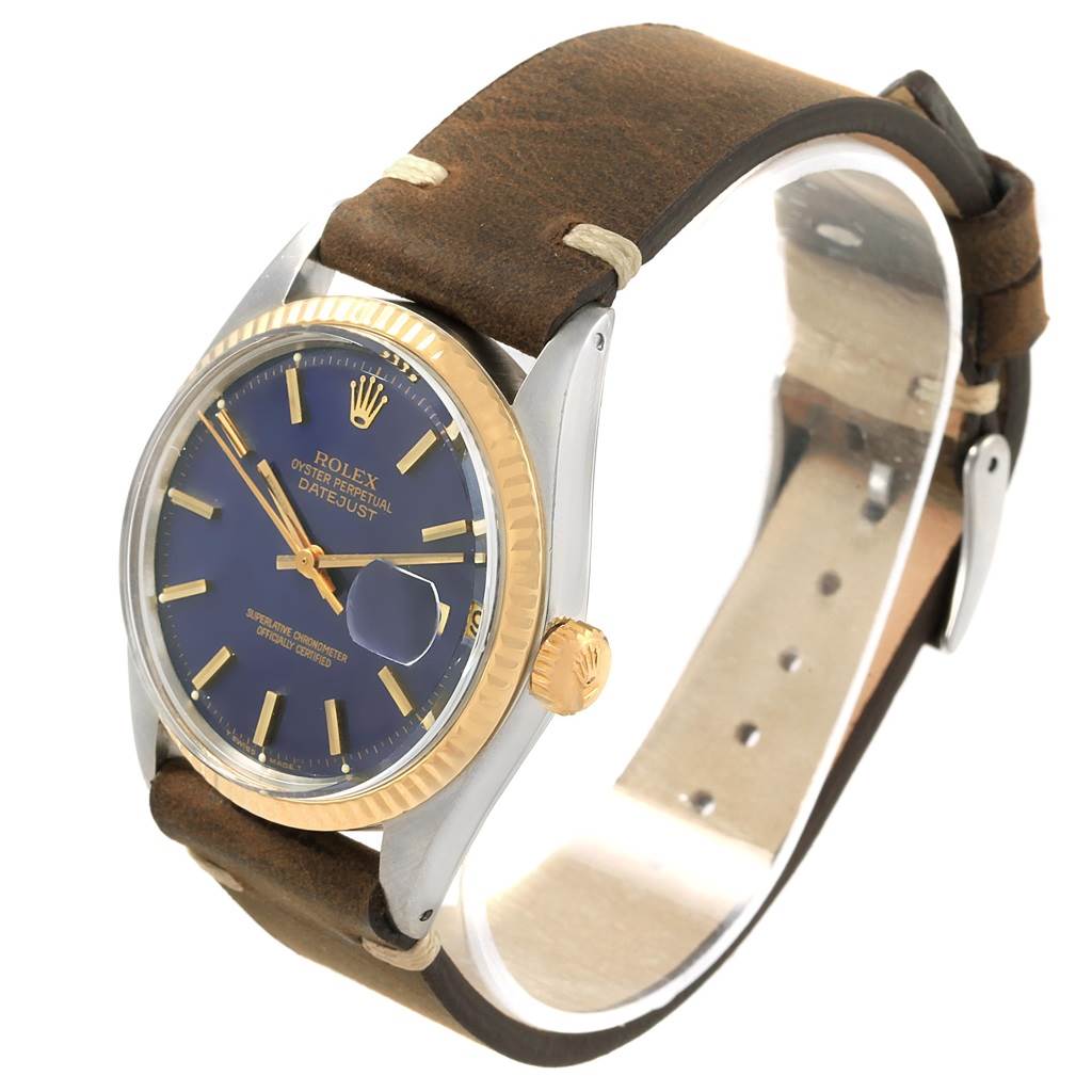 This image shows a Rolex Vintage Collection 1601 Men's Steel and Gold (two tone) Blue Dial 1601 Men's Steel and Gold (two tone) Blue Dial watch at an angled side view, highlighting the face, crown, and strap.