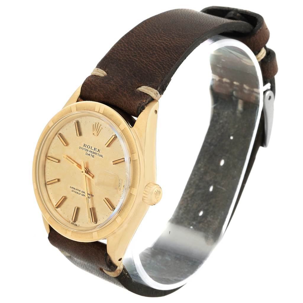 The image shows a side angle of a Rolex Vintage Collection 1501 Men's Yellow Gold Champagne Dial 1501 Men's Yellow Gold Champagne Dial watch, highlighting its gold case, dial, and brown leather strap.