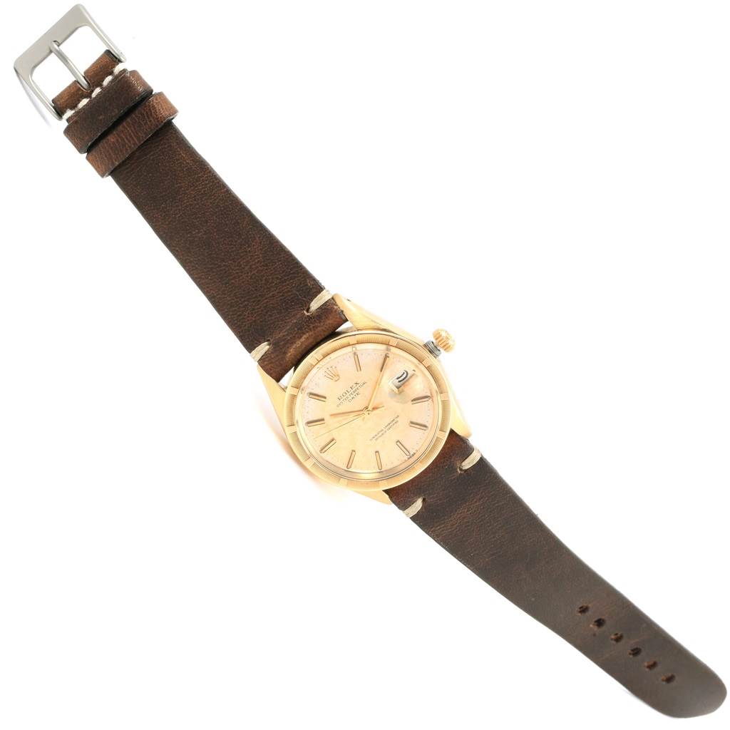 The Rolex Vintage Collection 1501 Men's Yellow Gold Champagne Dial 1501 Men's Yellow Gold Champagne Dial watch is shown from a top-down angle, featuring its brown leather strap, gold case, and dial.