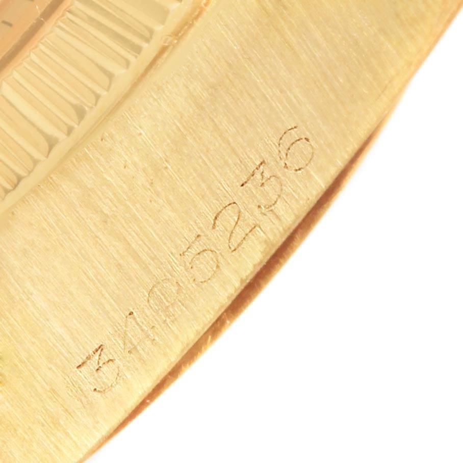 The image shows a close-up angle of the Rolex Vintage Collection 1807 Men's Yellow Gold Champagne Dial 1807 Men's Yellow Gold Champagne Dial model's engraved serial number and part of its fluted bezel.