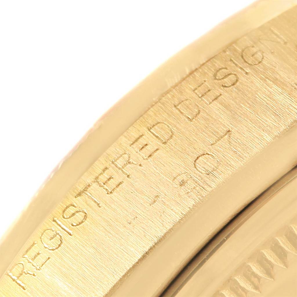 The image shows a close-up of the side engraving on a Rolex Vintage Collection 1807 Men's Yellow Gold Champagne Dial 1807 Men's Yellow Gold Champagne Dial watch.