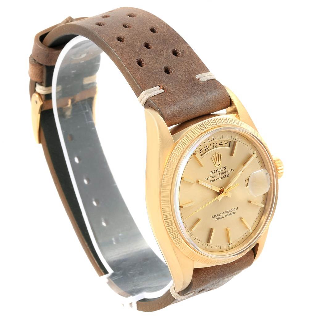 This Rolex Vintage Collection 1807 Men's Yellow Gold Champagne Dial 1807 Men's Yellow Gold Champagne Dial watch is shown from an angled top view displaying its gold dial, brown leather strap, and day-date feature.