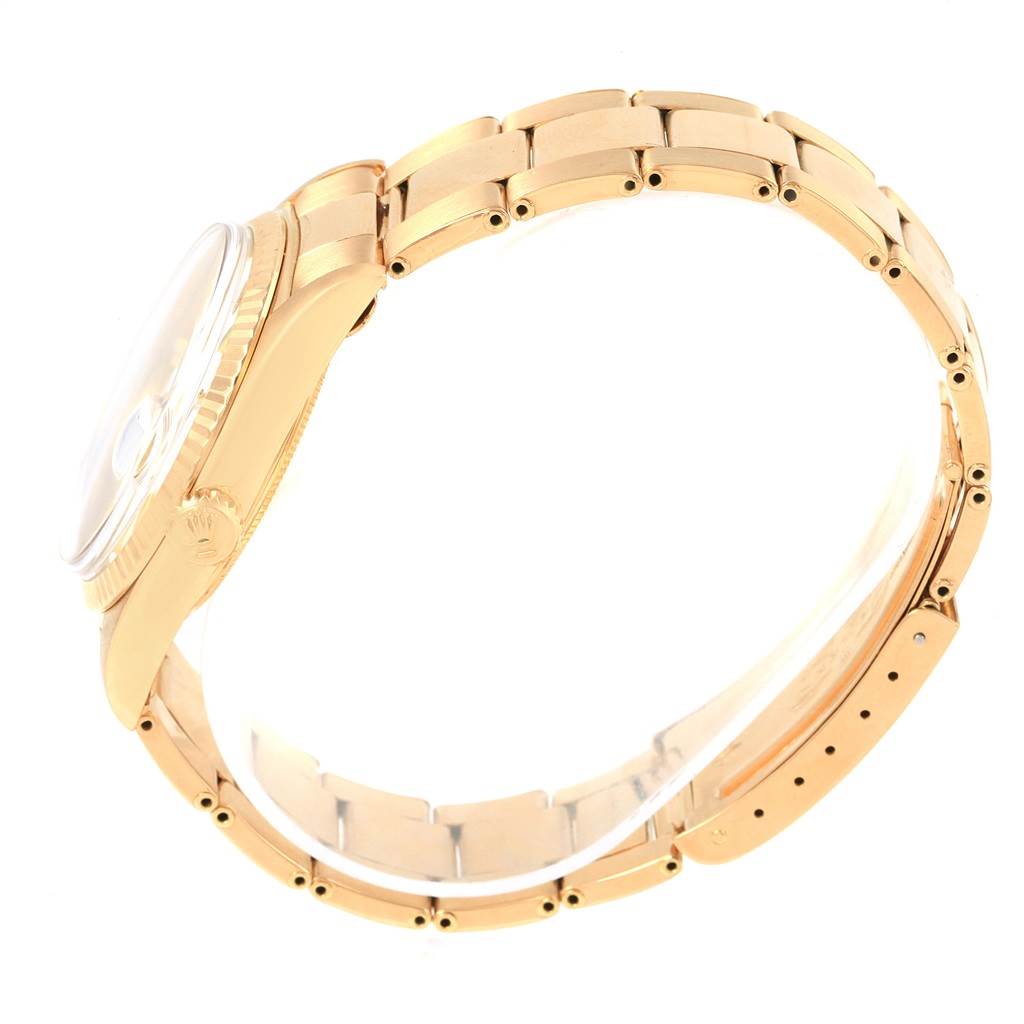 The image shows a side view of a Rolex Vintage Collection 1601 Men's Yellow Gold White Dial 1601 Men's Yellow Gold White Dial watch, displaying its gold bracelet and case.