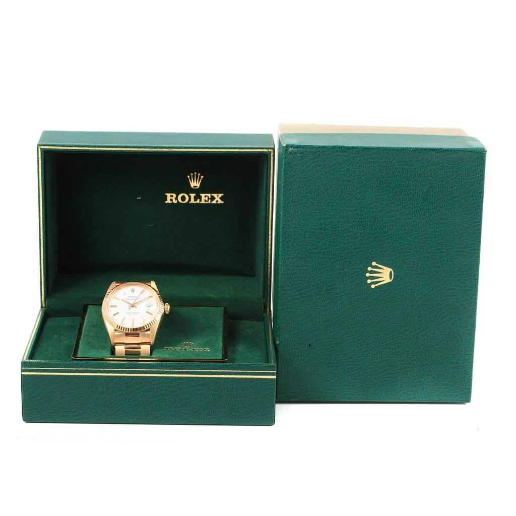 The image shows a Rolex Vintage Collection 1601 Men's Yellow Gold White Dial 1601 Men's Yellow Gold White Dial watch from a front angle, displayed in an open green box with the lid upright and an additional closed box beside it.