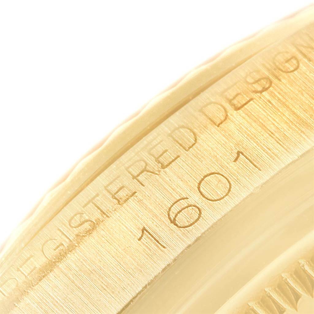 Close-up of the side view of a Rolex Vintage Collection 1601 Men's Yellow Gold White Dial 1601 Men's Yellow Gold White Dial watch, showing the engraved model number "1601."