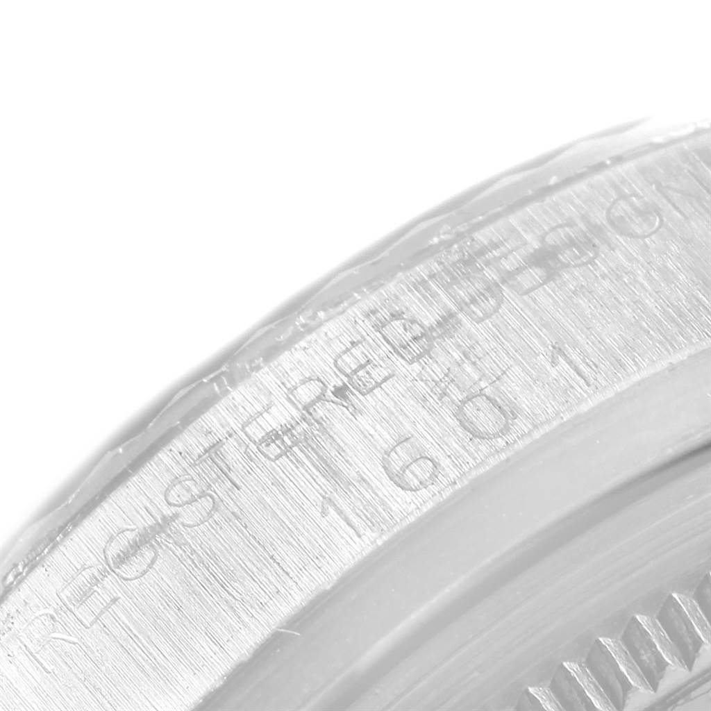 The image shows a close-up angle of the engraved bezel of a Rolex Vintage Collection 1601 Men's Stainless Steel Black Dial 1601 Men's Stainless Steel Black Dial model.