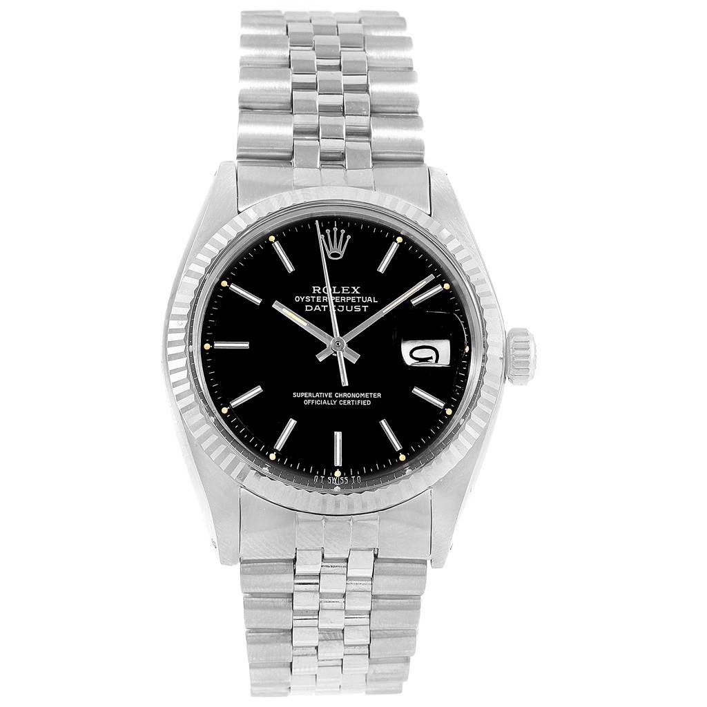The image shows a front view of the Rolex Vintage Collection 1601 Men's Stainless Steel Black Dial 1601 Men's Stainless Steel Black Dial Datejust watch, displaying its black dial, fluted bezel, and stainless steel bracelet.