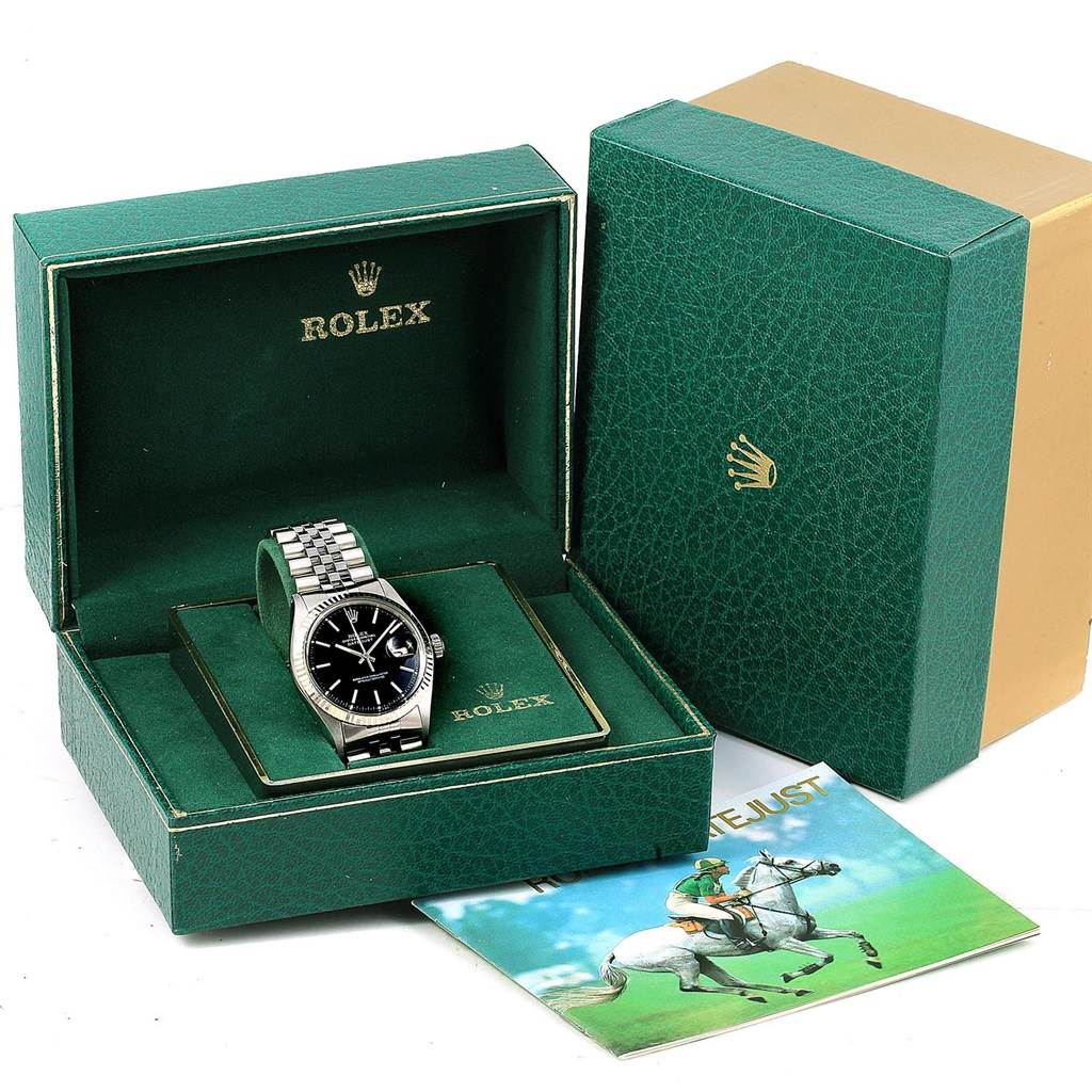 The Vintage Collection Rolex watch is shown in its green open box with a booklet beside it.