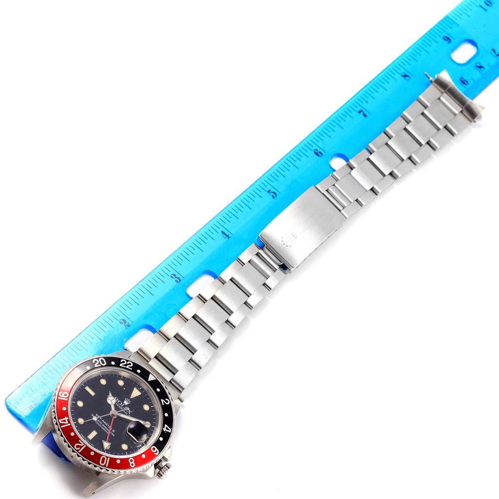 This image shows a Rolex Vintage Collection 16760 Men's Stainless Steel Black Dial 16760 Men's Stainless Steel Black Dial watch at a top-down angle, featuring the dial and metal bracelet alongside a ruler for scale.