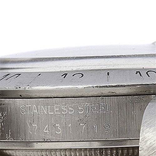 This close-up image shows the stainless steel bezel and engraved serial number of a Rolex Vintage Collection 1655 Men's Stainless Steel Black Dial 1655 Men's Stainless Steel Black Dial model watch.