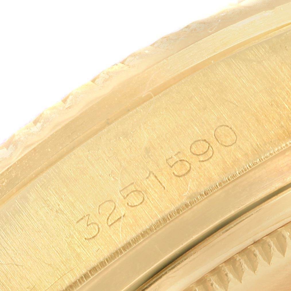 This close-up image shows the engraved serial number on the gold casing of a Vintage Collection Rolex watch.