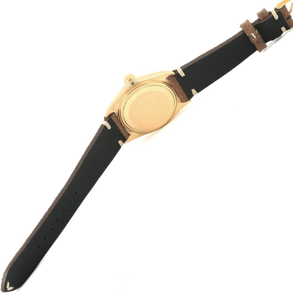 The image shows the back side of the Rolex Vintage Collection 1803 Men's Yellow Gold Silver Dial 1803 Men's Yellow Gold Silver Dial watch with its leather strap extended.