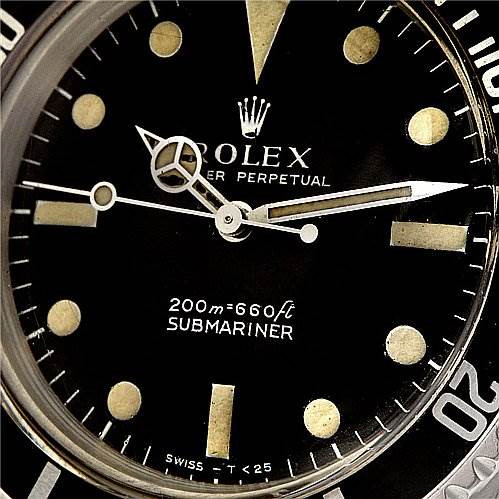 The image shows a close-up of the dial and bezel of the Vintage Collection Rolex Submariner watch.