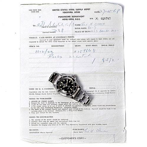 The image shows the face and bracelet of a Vintage Collection Rolex watch, placed on a purchase document.