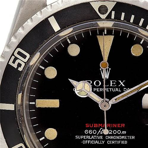The image shows a close-up angle of a Rolex Submariner Vintage Collection watch, focusing on the dial and bezel.