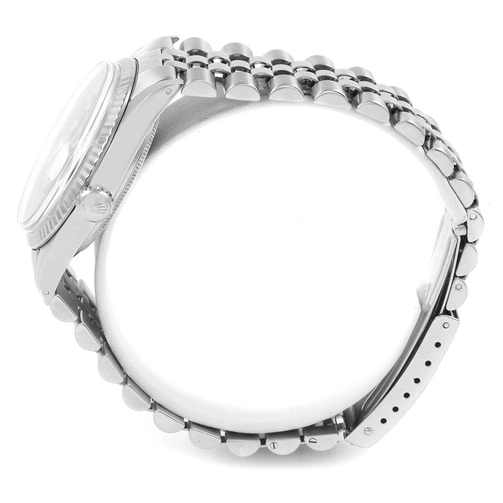 The image shows a side view of a Rolex Vintage Collection 1601 Men's Stainless Steel Black Dial 1601 Men's Stainless Steel Black Dial watch, highlighting its metal bracelet, clasp, and side of the case.