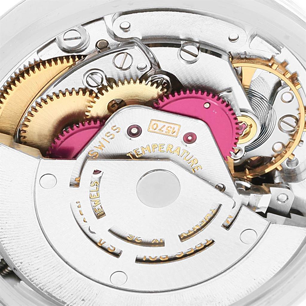The image shows the intricate internal mechanics of a Vintage Collection Rolex watch, highlighting gears and the movement mechanism.