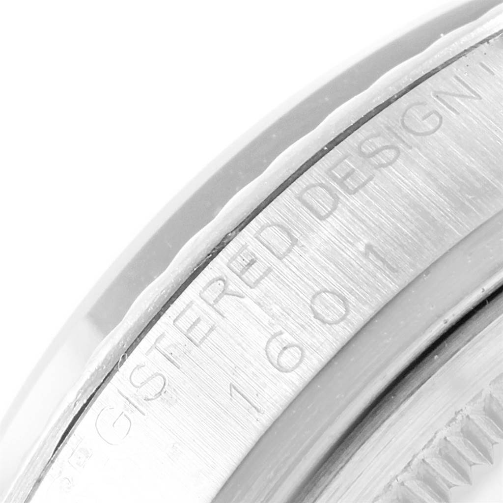 This close-up image shows the serial and design numbers engraved on the bezel of a Vintage Collection Rolex watch.
