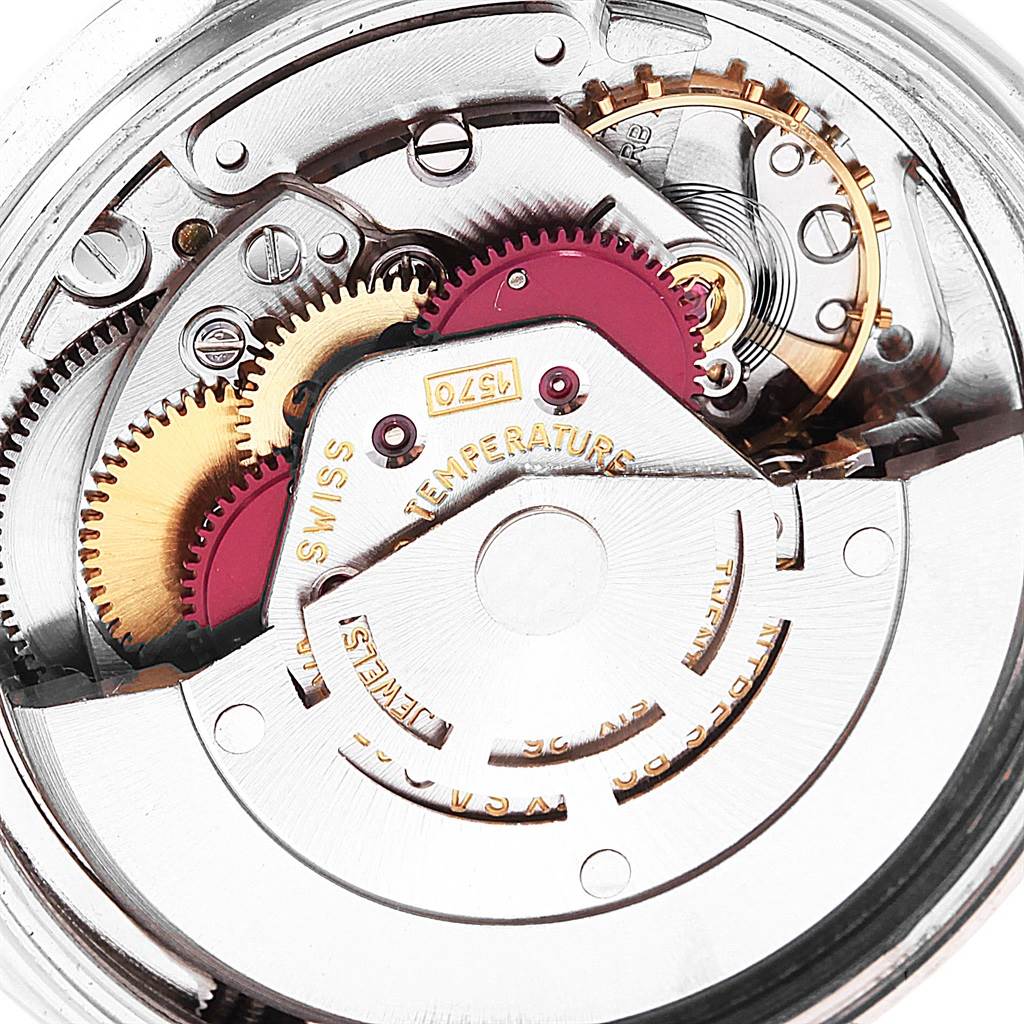 This image shows a close-up of the inner mechanism of a Rolex Vintage Collection 1601 Men's Stainless Steel Silver Dial 1601 Men's Stainless Steel Silver Dial watch, highlighting the gears and movement parts.