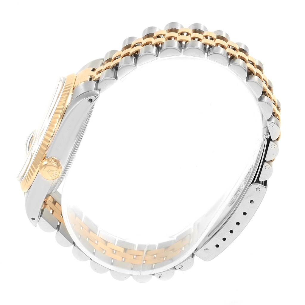 The image shows a side view of the Rolex Vintage Collection 16013 Men's Stainless Steel White Dial 16013 Men's Stainless Steel White Dial watch, highlighting the two-tone bracelet and the watch crown.