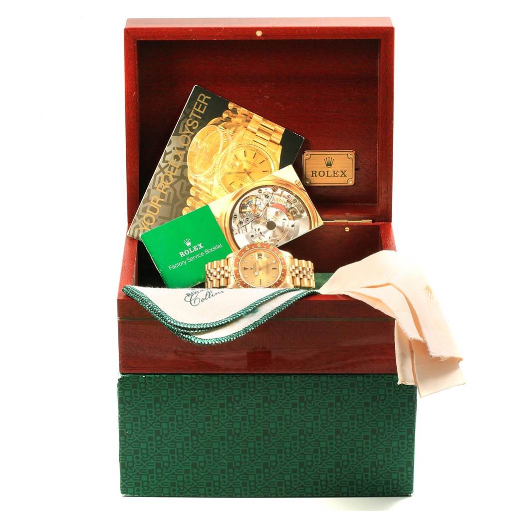 The image shows a Rolex Vintage Collection 16758 Men
s Yellow Gold Champagne Dial 16758 Men
s Yellow Gold Champagne Dial watch in its box with booklets, cloths, and display accessories.