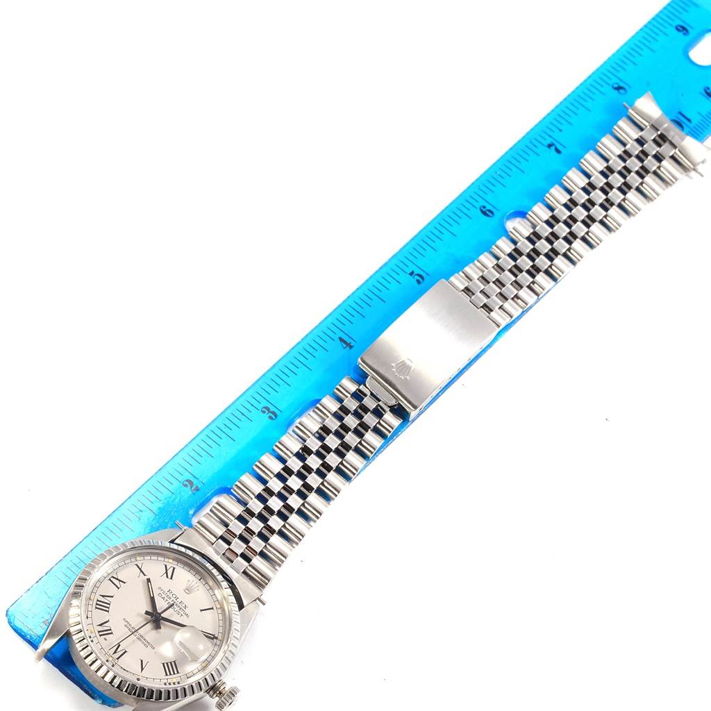 The image shows a Rolex Vintage Collection 16030 Men
s Stainless Steel Grey Dial 16030 Men
s Stainless Steel Grey Dial watch, laid flat with the face, bracelet, and clasp visible next to a ruler for scale.