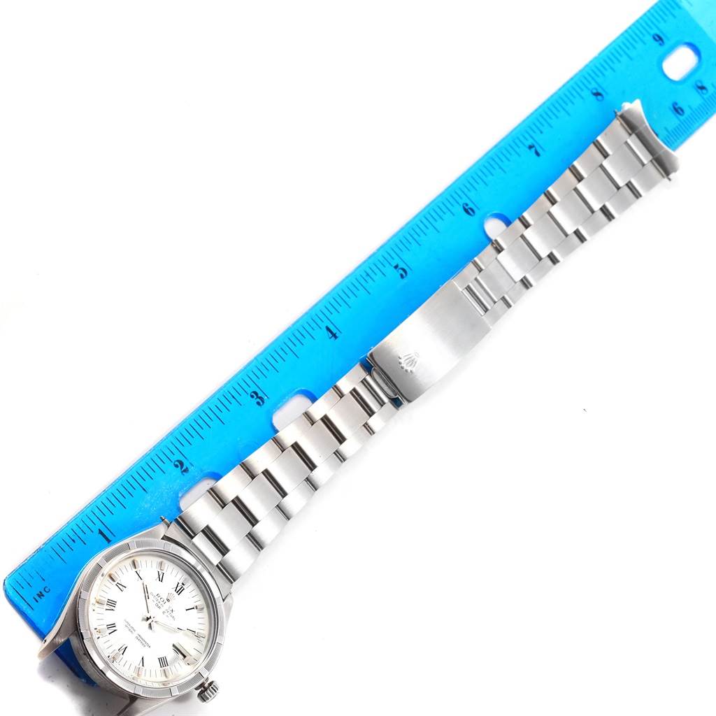 The image shows a Rolex Vintage Collection 15010 Men's Stainless Steel White Dial 15010 Men's Stainless Steel White Dial watch laid flat next to a ruler, displaying the dial, bracelet, and clasp.