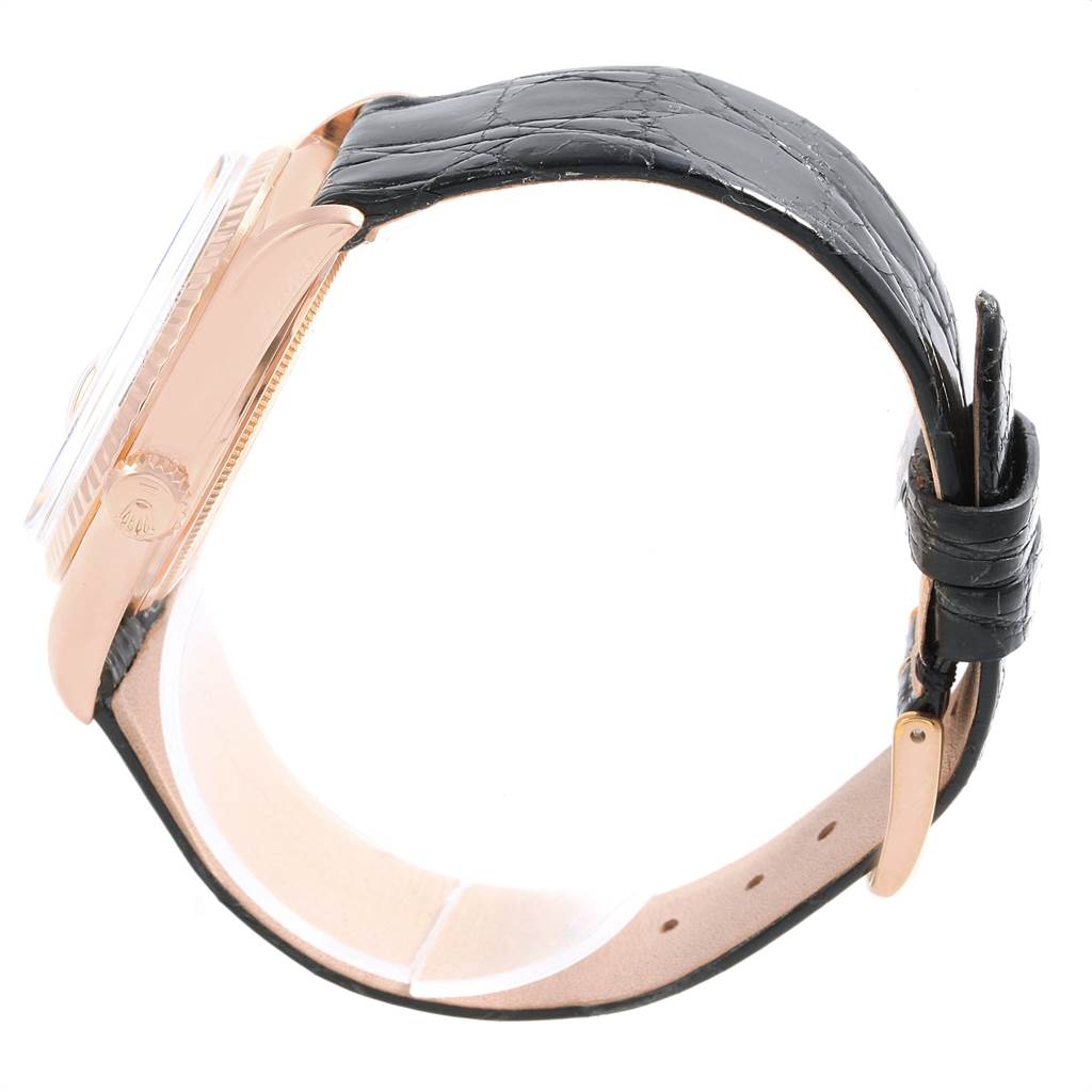 The image shows a side view of a Vintage Collection Rolex watch with its black leather strap and rose gold case.