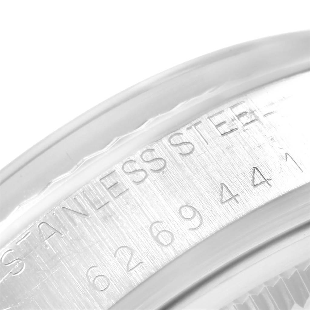 This image shows a close-up of the serial number and "STAINLESS STEEL" engraving on the case of a Rolex Vintage Collection 16014 Men's Stainless Steel Blue Dial 16014 Men's Stainless Steel Blue Dial watch.