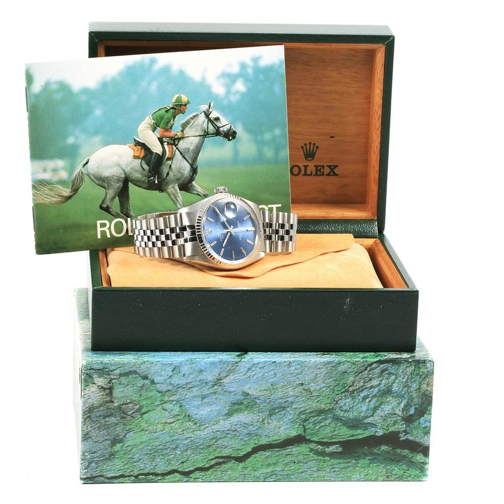 The Vintage Collection Rolex watch is displayed in its box with a booklet, showing the face, bracelet, and crown prominently.