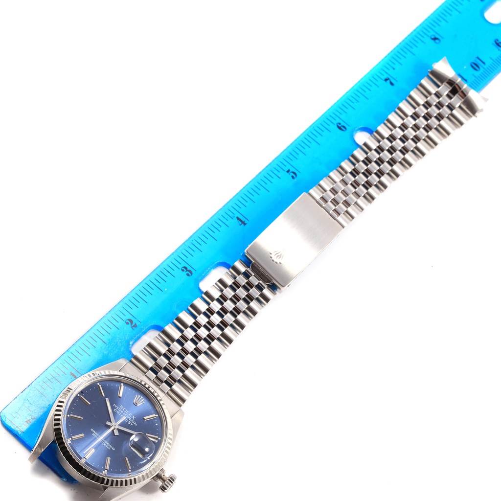 The image shows a top-down view of a Vintage Collection Rolex watch alongside a blue ruler for scale.