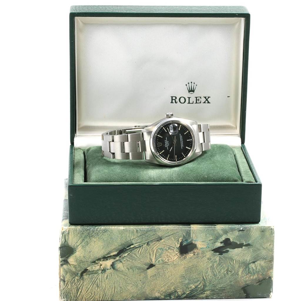 The Rolex Vintage Collection 1500 Men's Stainless Steel Black Dial 1500 Men's Stainless Steel Black Dial watch is displayed in its green, open box, showing the watch face, bracelet, and crown from a front angle.