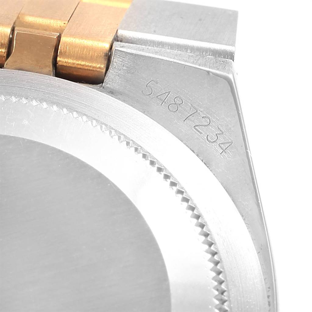 This image shows the case and part of the bracelet of a Rolex Vintage Collection 1630 Men's Steel and Gold (two tone) Champagne Dial 1630 Men's Steel and Gold (two tone) Champagne Dial watch, focusing on the serial number.